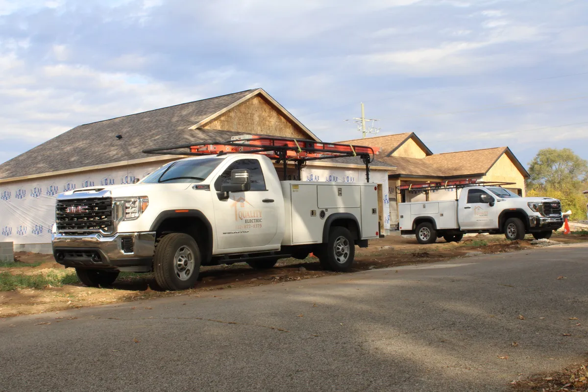 Quality Electric Trucks parked outside the Southard Acres West subdivision during development.